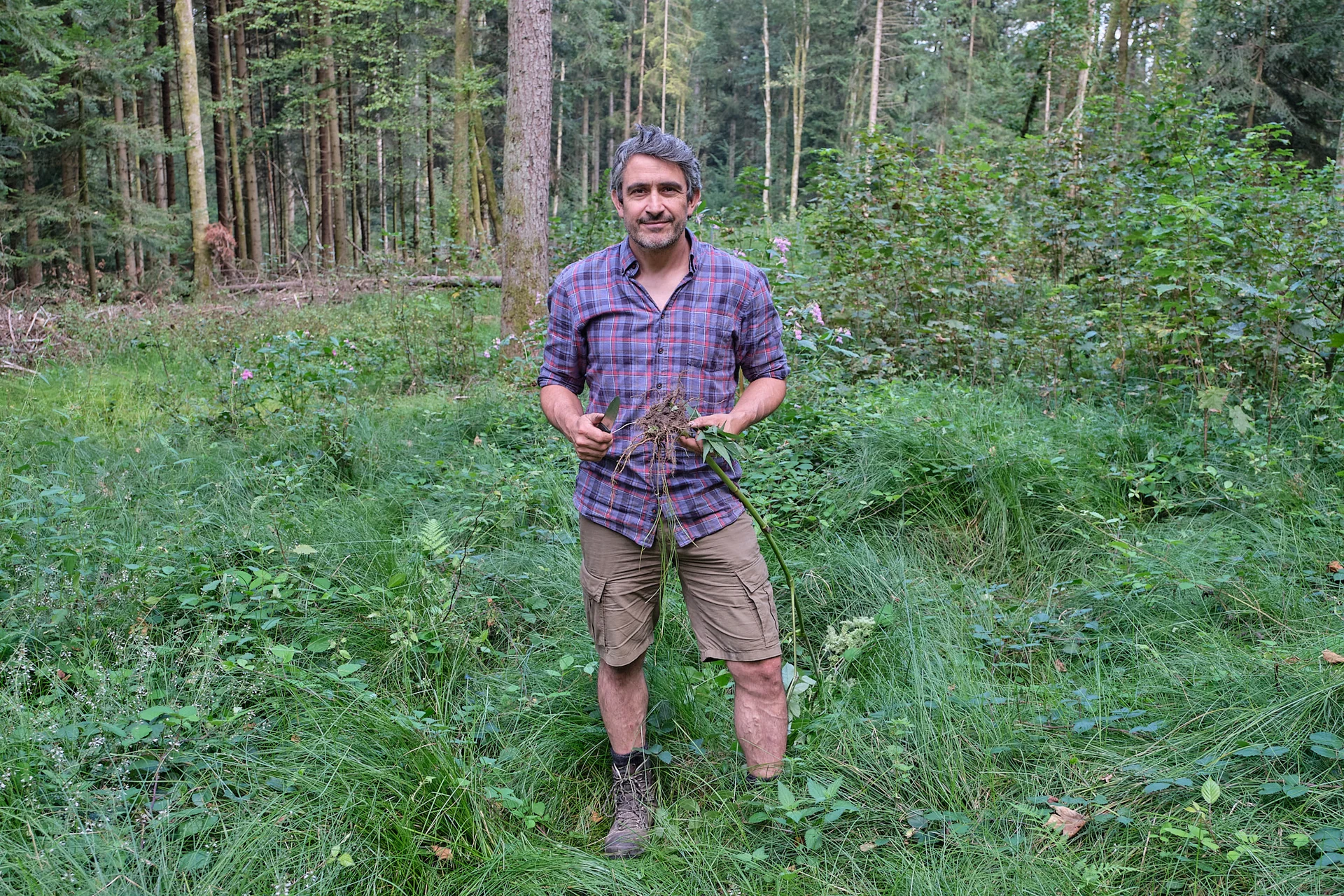 Lars Konarek mit Wildpflanzen beim Survival Training im Schwarzwald